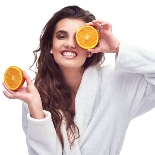 Woman holding orange to boost immunity.