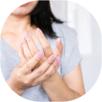 Woman holding aching fingers.